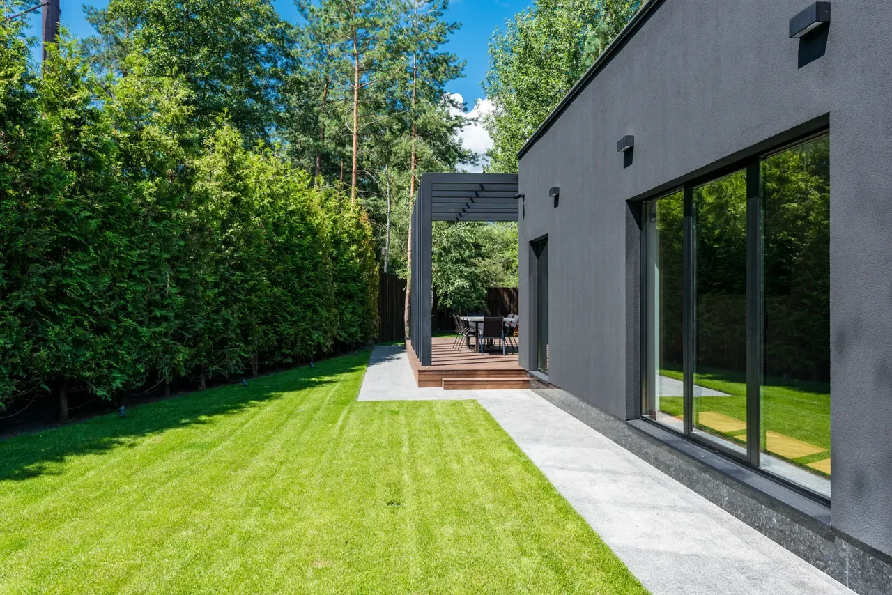 Modern house and landscaped garden, illustrative stock photography.